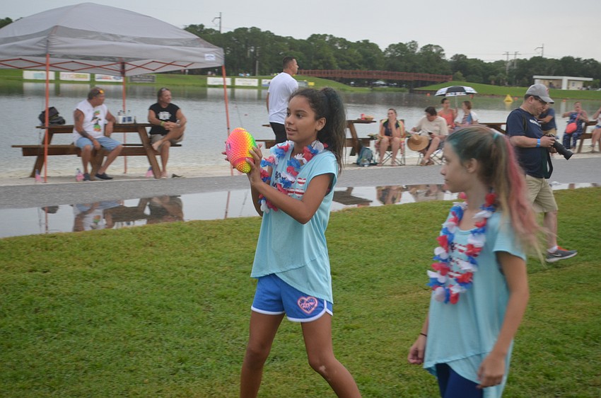 Bradenton's Serena Velasquez and Kylee Untisz play games before the rain hit.