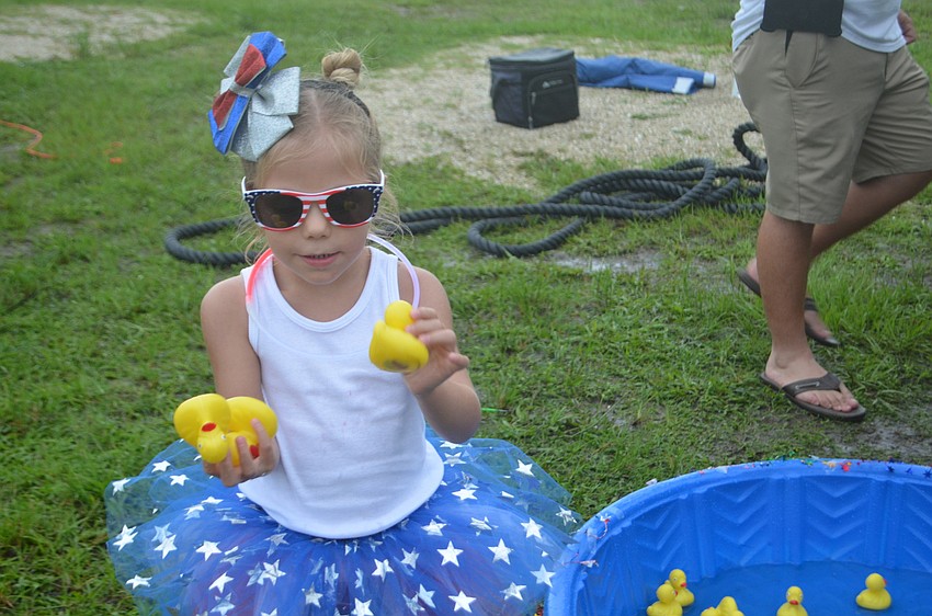Sarasota 4-year-old Frankie Haines has her hands full with a rubber duck game.