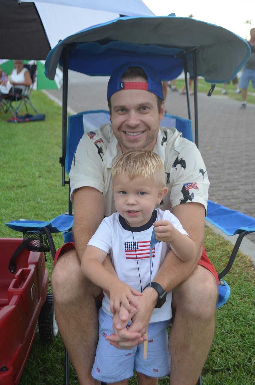 Ellenton's Matt Neitzel and his 2-year-old son, Parker, are prepared for the rain.