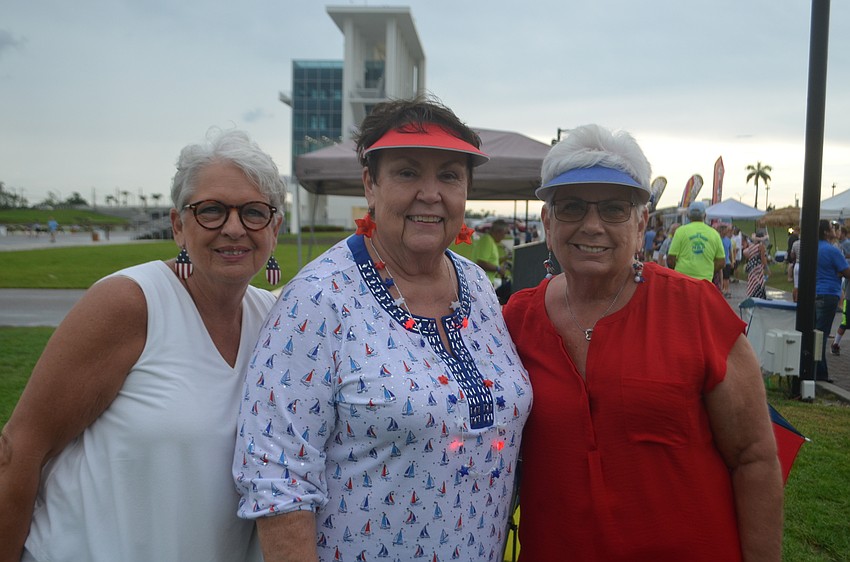 Bradenton's Becky Mannon, Linda Huffman and Sandy Snurr have high spirits despite the rain.