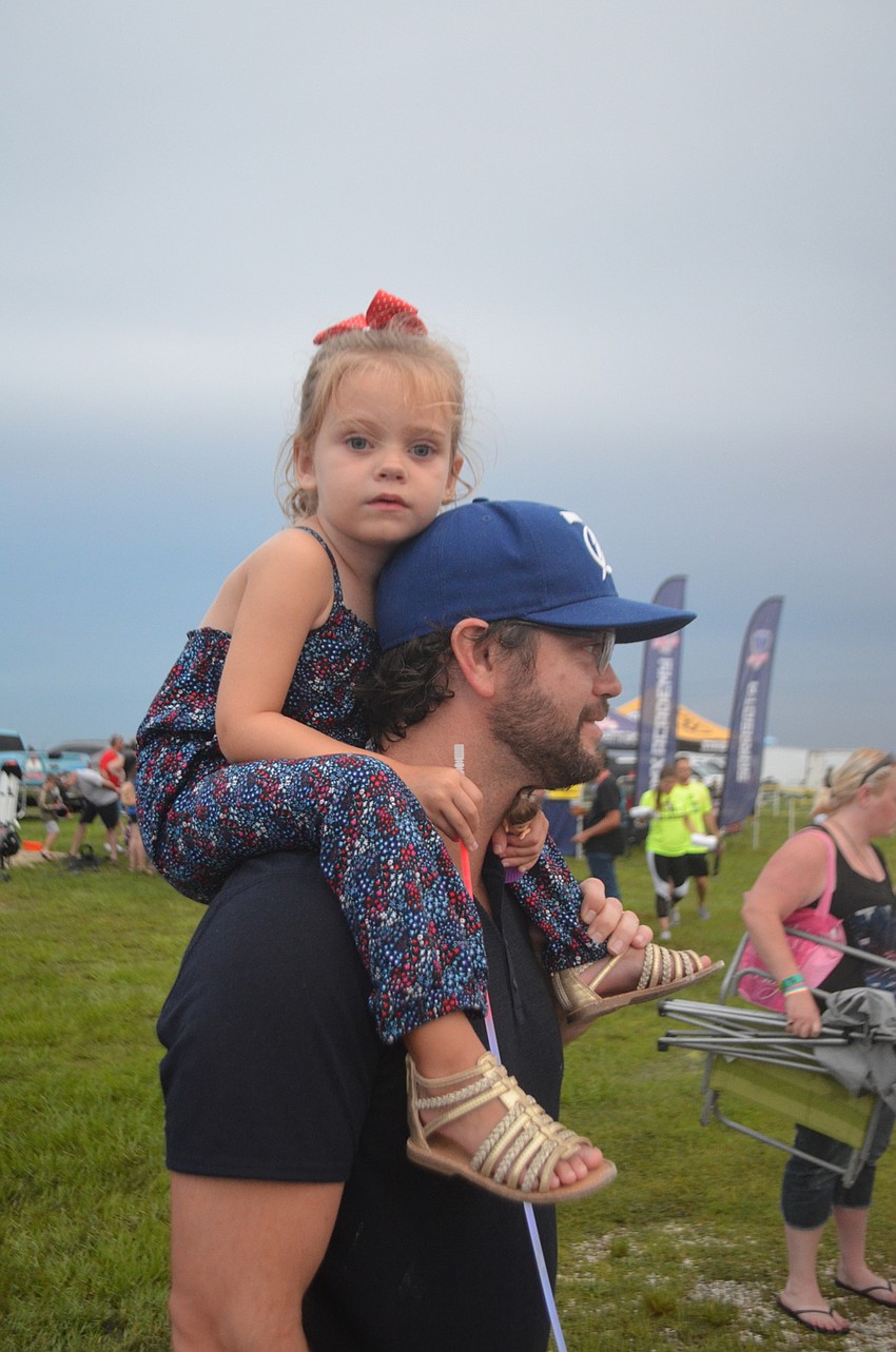 Lakewood Ranch 3-year-old Virginia Lanham has a great seat for the event on her dad, Craig's, shoulders.