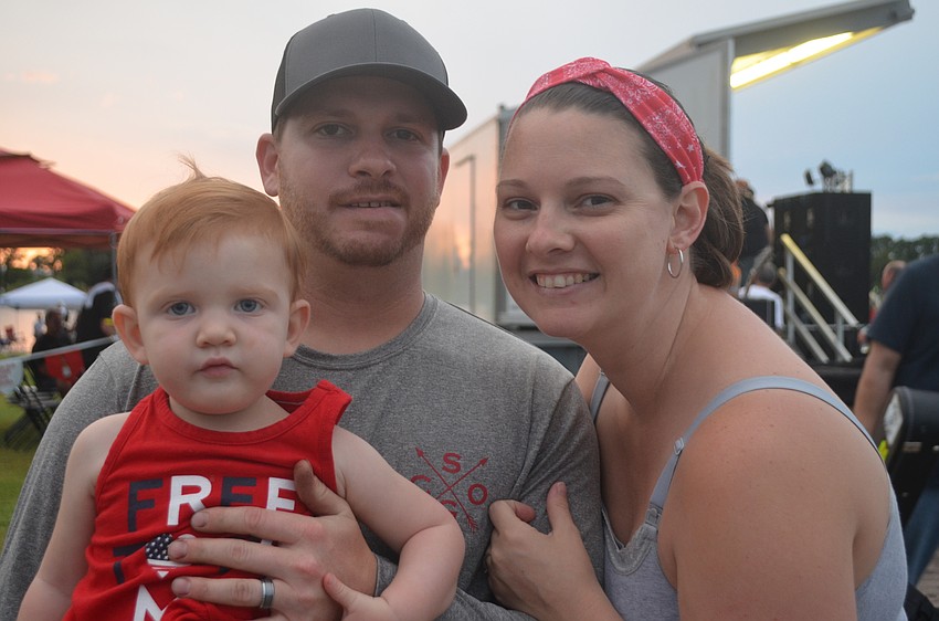 Bradenton 1-year-old Raelynn Steinberger and her parents Michelle Steinberger and David Steinberger relax between music performances.