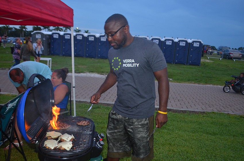 University Park's George Parker grills burgers before the fireworks show.