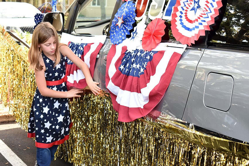 Camille Géhan decorates a car for the parade.