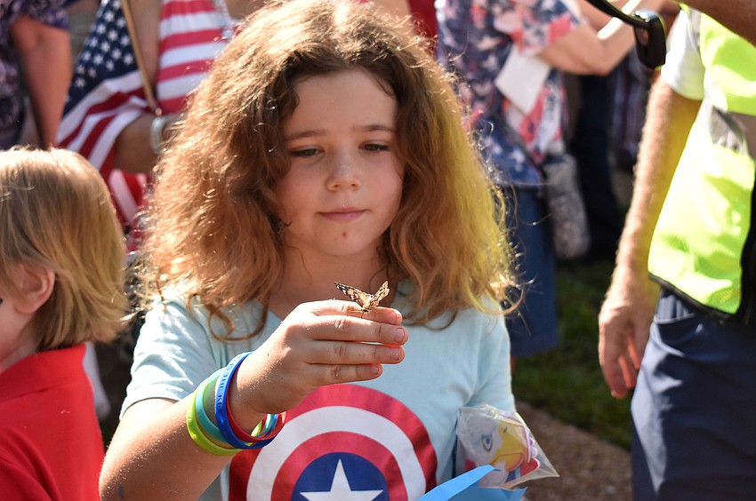 Leilah Miller releases a butterfly.