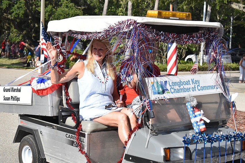 Grand Marshal Susan Phillips waves to the crowd.