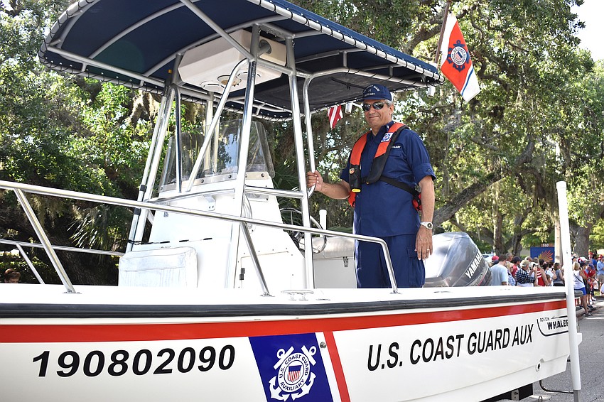The U.S. Coast Guard parades their new vessel on Bay Isles Road.