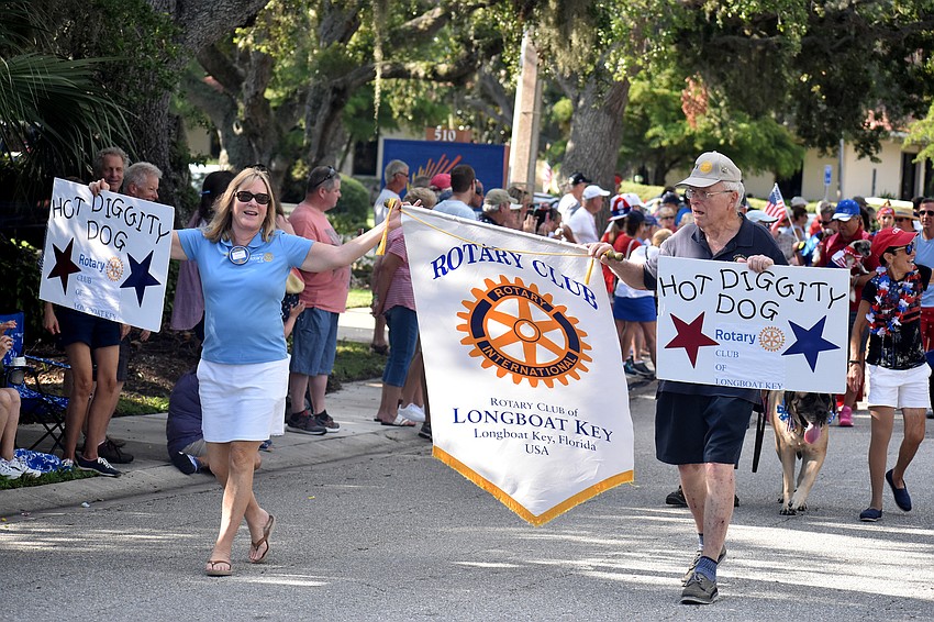 The Rotary Club of Longboat Key leads the dogs down Bay Isles Road.