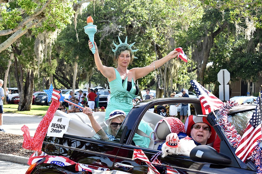 Irina LaRose waves to the crowd as the Statue of Liberty on the Design 2000 Float.
