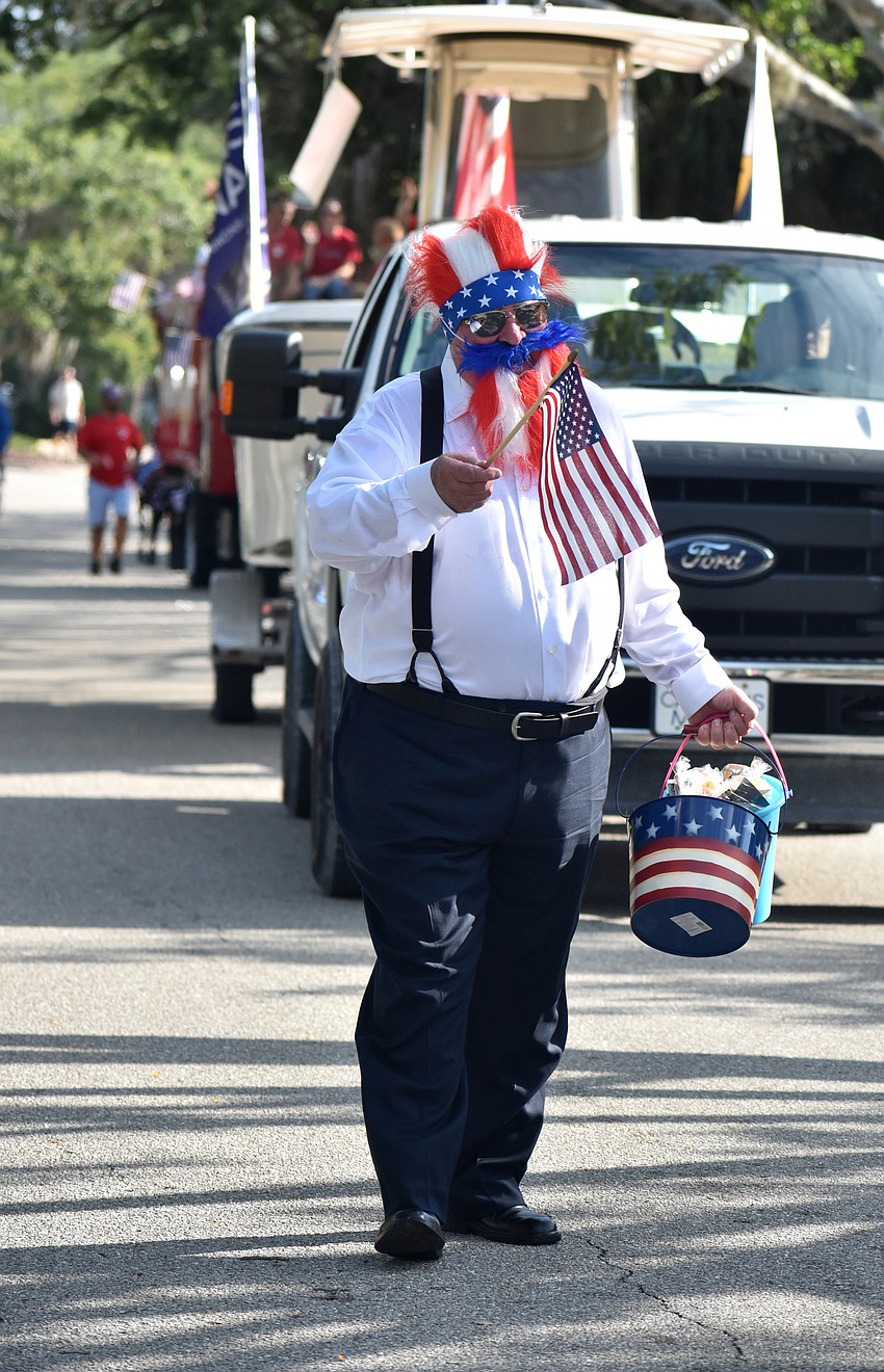 Steven Newman waves to the crowd during the parade.