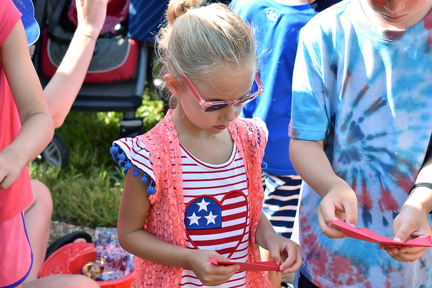 Mary Ellen Forshey opens an envelope to release a butterfly.