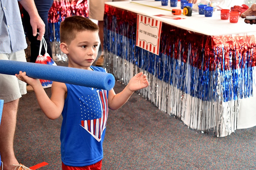 Sterling Nathan attempts to throw a pool noodle through a ring.