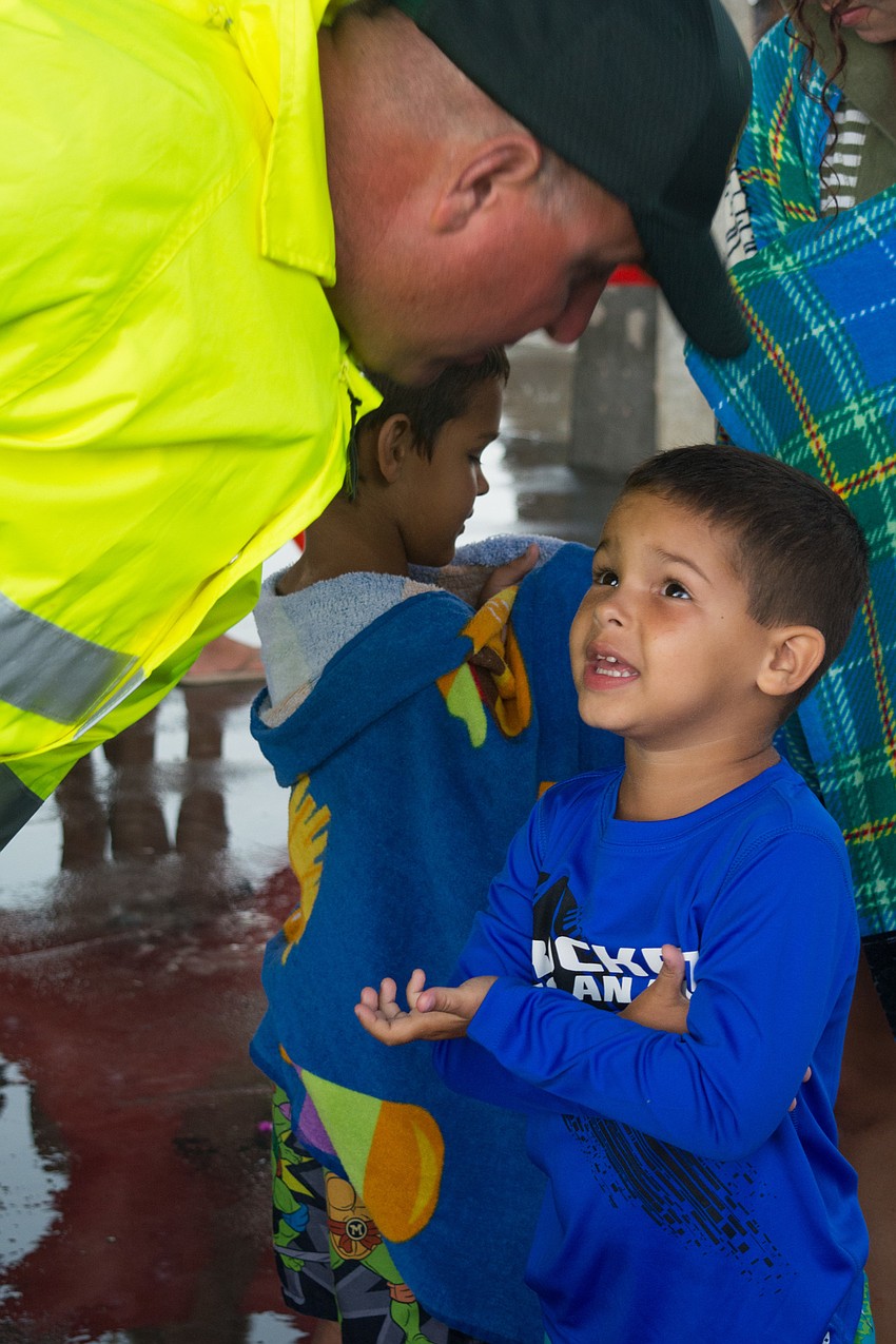 Mako Usher asks a sheriff on duty when the rain will stop.