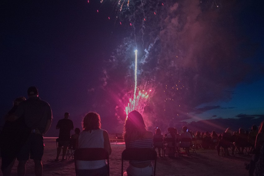 Spectators awe at the fireworks show at Siesta Key Beach.