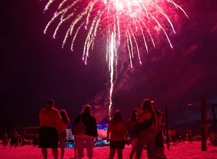 Spectators awe at the fireworks show at Siesta Key Beach.