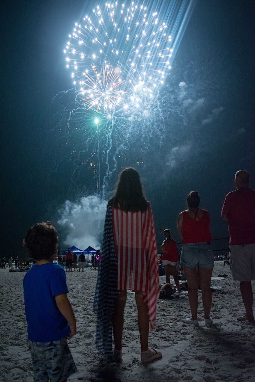 Dora Kostic dons an American flag as she gazes at the fireworks show.