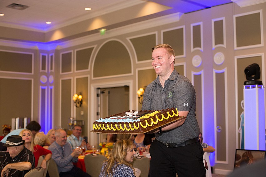 Kyle Jesse shows off the birthday cake.