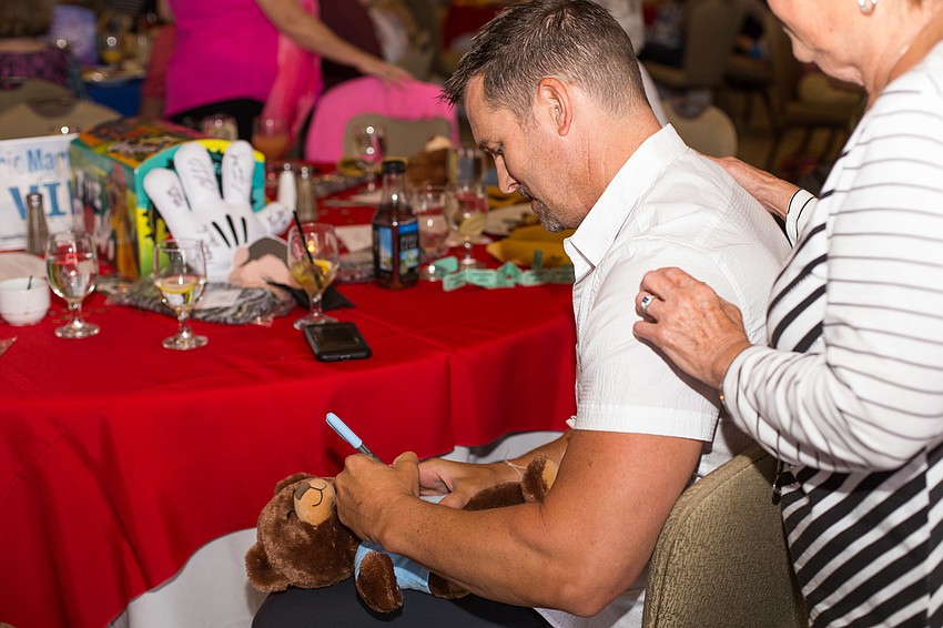 Eric Martsolf signs bears for guests.