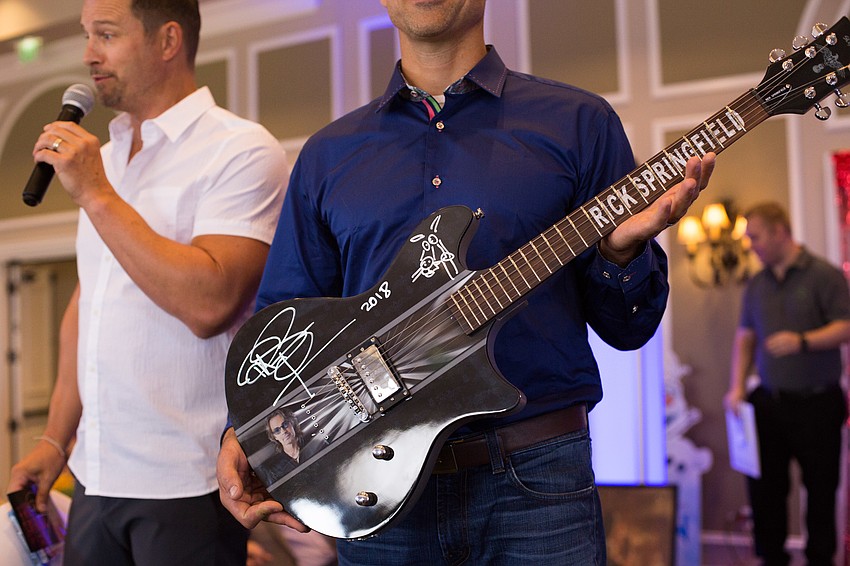 A Rick Springfield-signed guitar was purchased in the live auction for $800.
