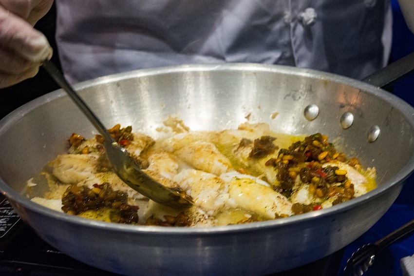 Servings of pan seared lionfish are prepared for the tasting.