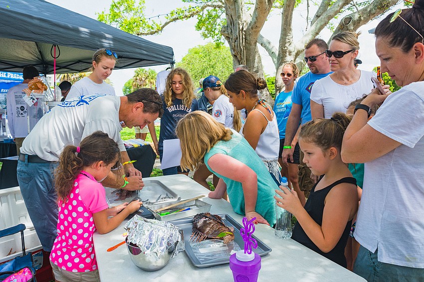 Attendees observe a lionfish dissection.