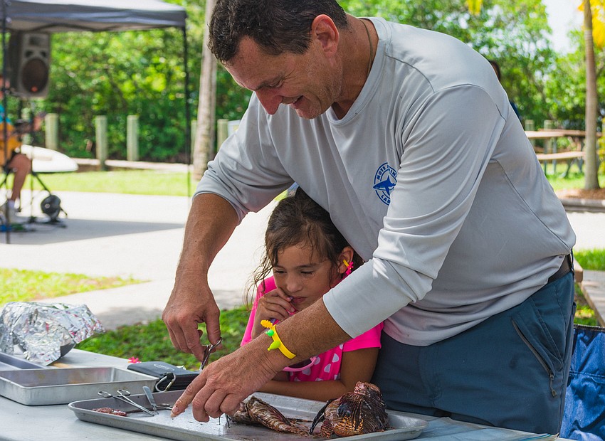 James and Isabella Locascio dissect a lionfish together.