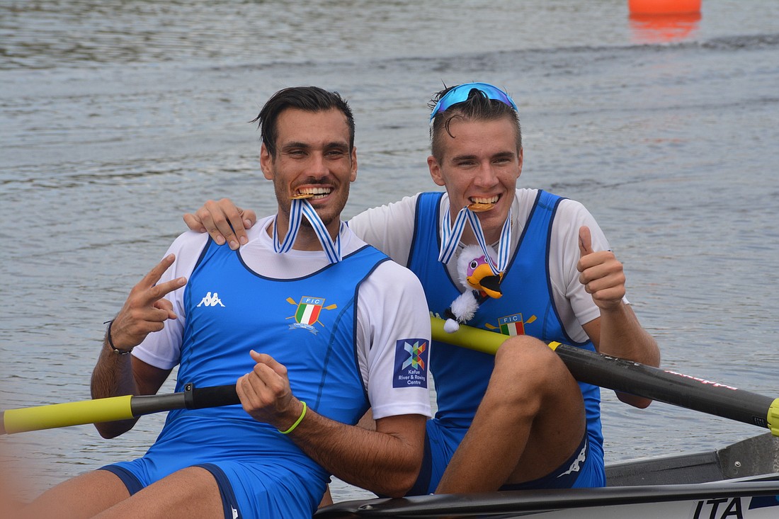 Italy&#39;s gold-medal winning Men&#39;s Pair of Giuseppe Vicino and Matteo Lodo test how the medals taste at the 2017 World Rowing Championships. File photo.