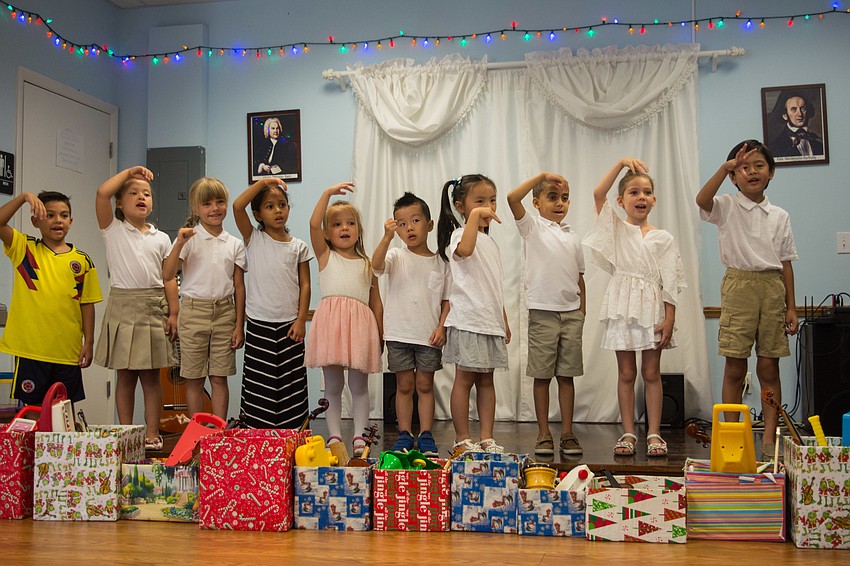 Campers use hand signals for singing different pitches.