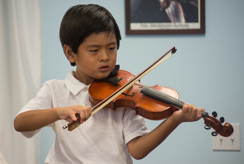 Quincy Tran plays the violin.