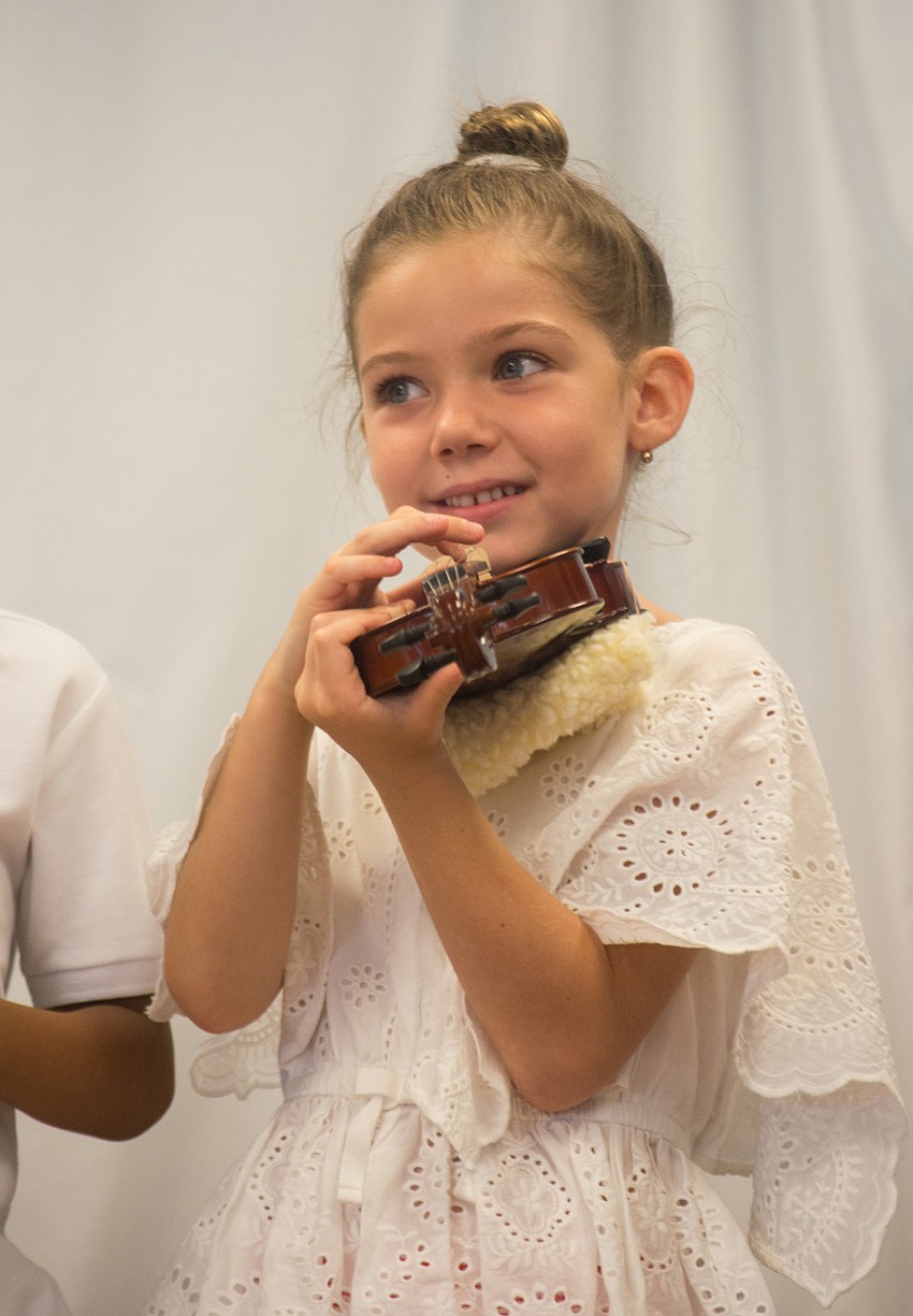 Fiona Quinto-Halt plucks a violin.