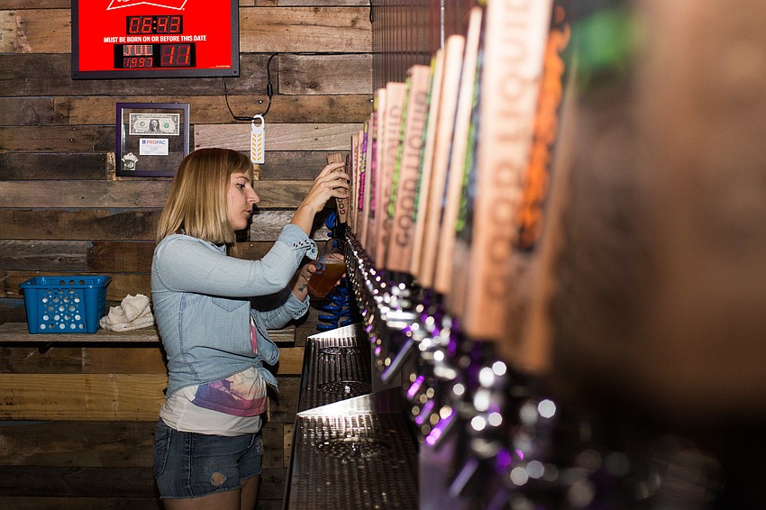 Kristen Erlich pours a pint of beer.
