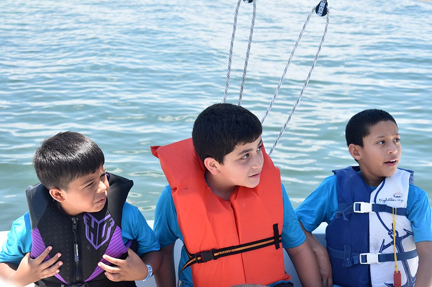 Yariel Davila, Sebastian Camacho and  Elias Gonzales listen to safety instructions.
