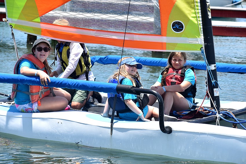 Lillian Coblentz, Rebecca Coblentz and Celine Batts, accompanied by Sarasota Youth Sailing coaches, sail around Sarasota Bay.