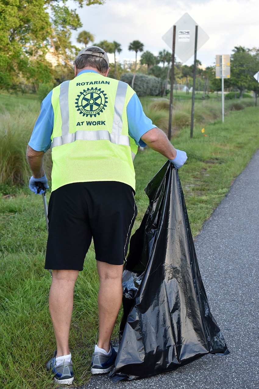 Jack Rozance makes his way down Gulf of Mexico Drive while picking up trash.