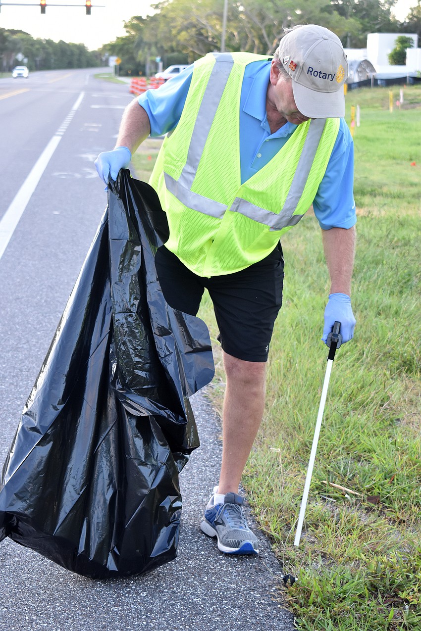 Jack Rozance picks up trash along Gulf of Mexico Drive.