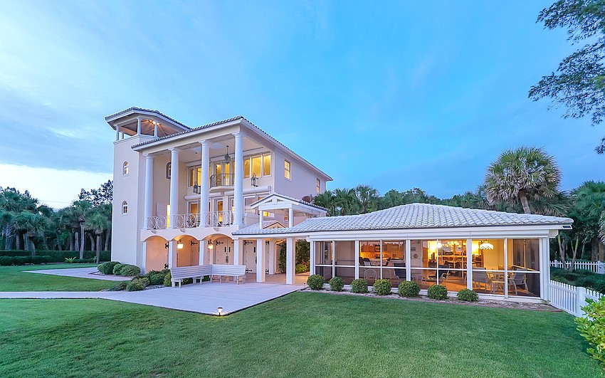 The three-story guest house features an elevator and surrounding waterfront views.