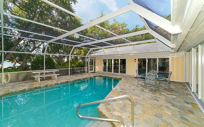 The pool of the main home looks out over the bayfront.