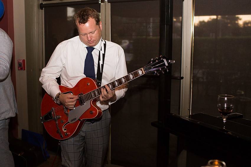 Brian Mariash plays guitar.