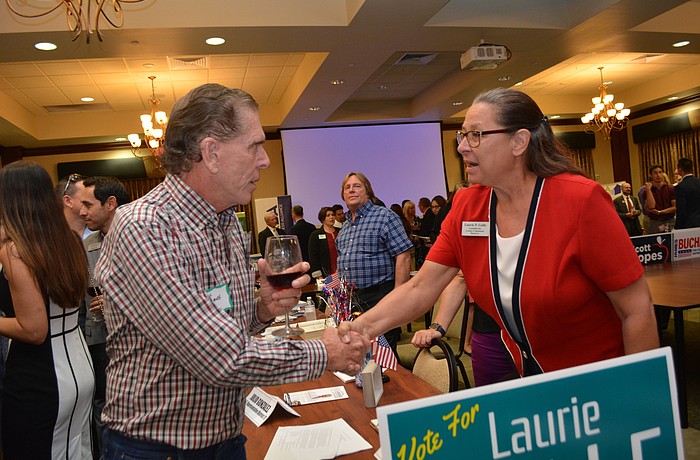 River Club's Phil Gurghardt talks with Manatee County Commission candidate Lauri Galle, who has attended every commission workshop and meeting for more than six months.