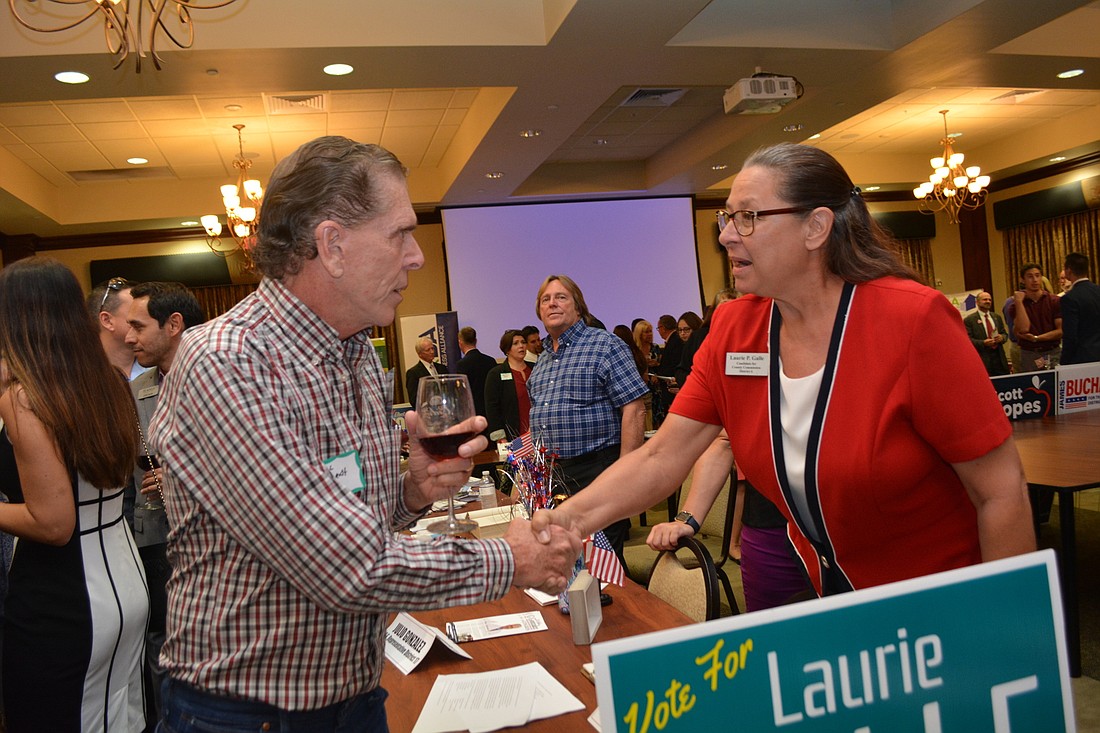 River Club&#39;s Phil Gurghardt talks with Manatee County Commission candidate Lauri Galle, who has attended every commission workshop and meeting for more than six months.