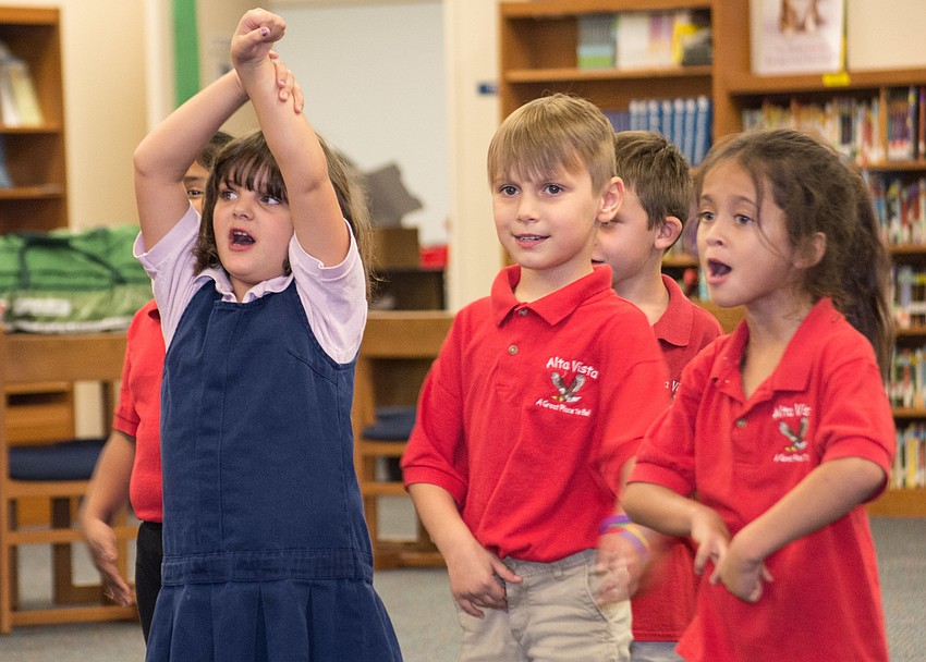Scarlet Roberts, Maximilian Philips and Elianna Rodriguez follow along to a dance  routine.