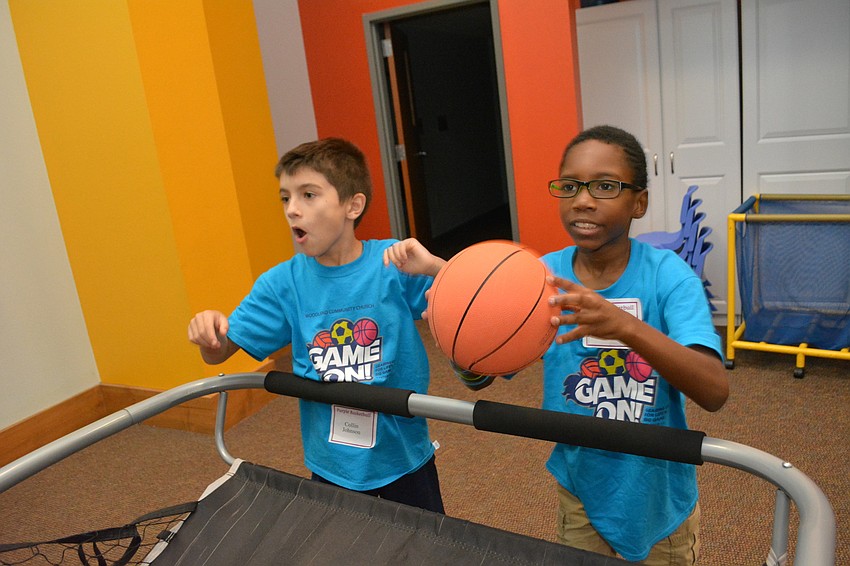 Collin Johnson and Danny Stratton, both 8, shoot hoops before heading to the bounce house.