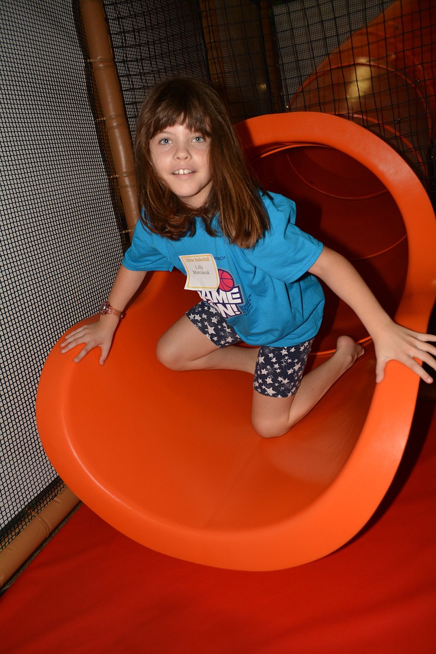 Lilly Marcincuk, 7, chases a friend down the slide at The Treehouse playground.