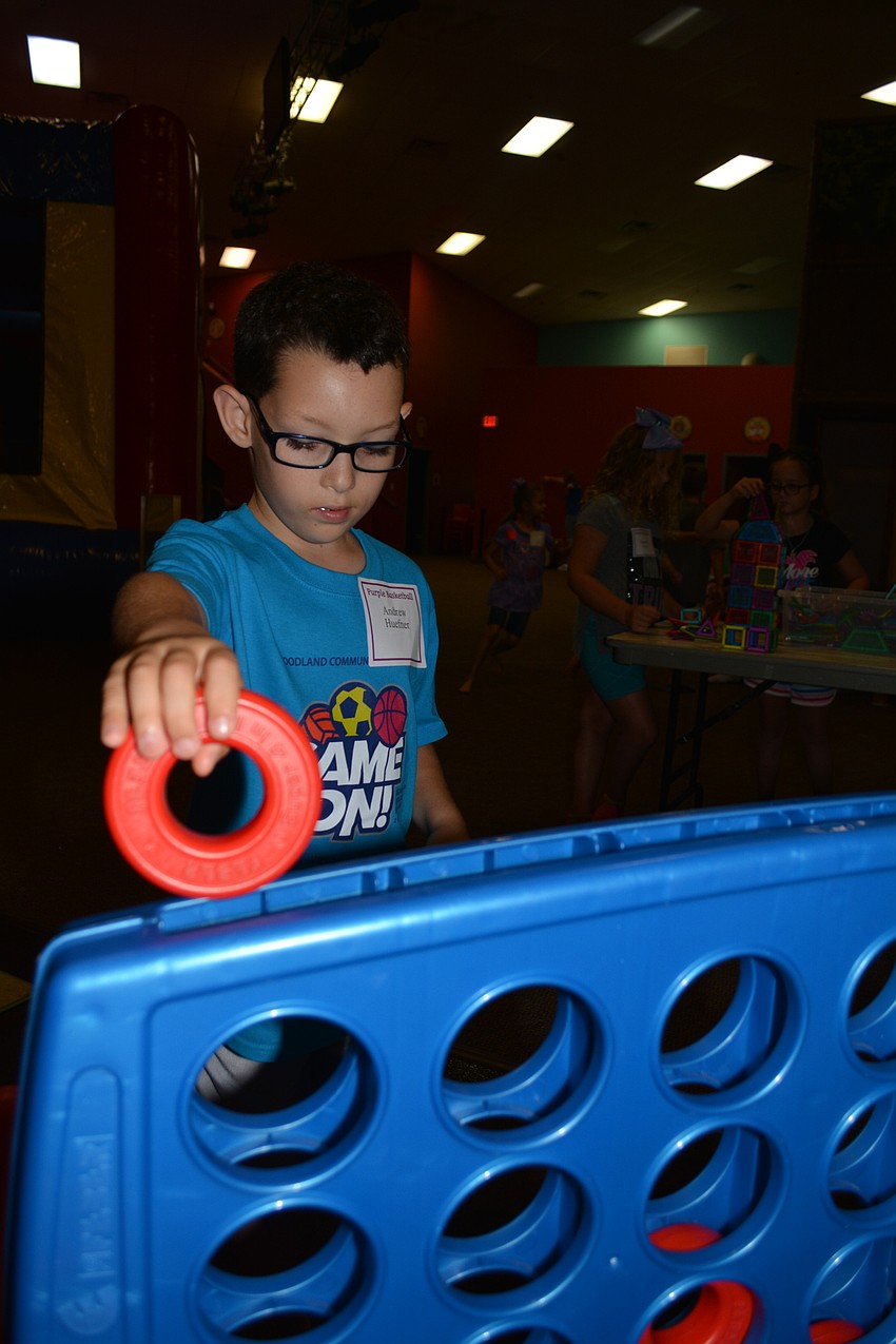 Gullett Elementary School's Andrew Huefner, 8, plays a giant game of Connect 4 with counselor Colin Farrell, not pictured.
