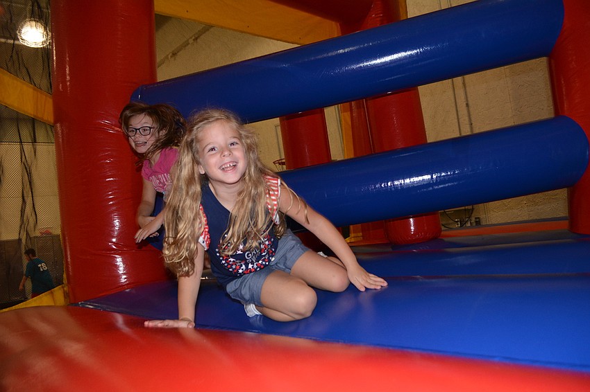 GreyHawk Landing's Olivia Rushmore has a blast  on an inflatable obstacle course.