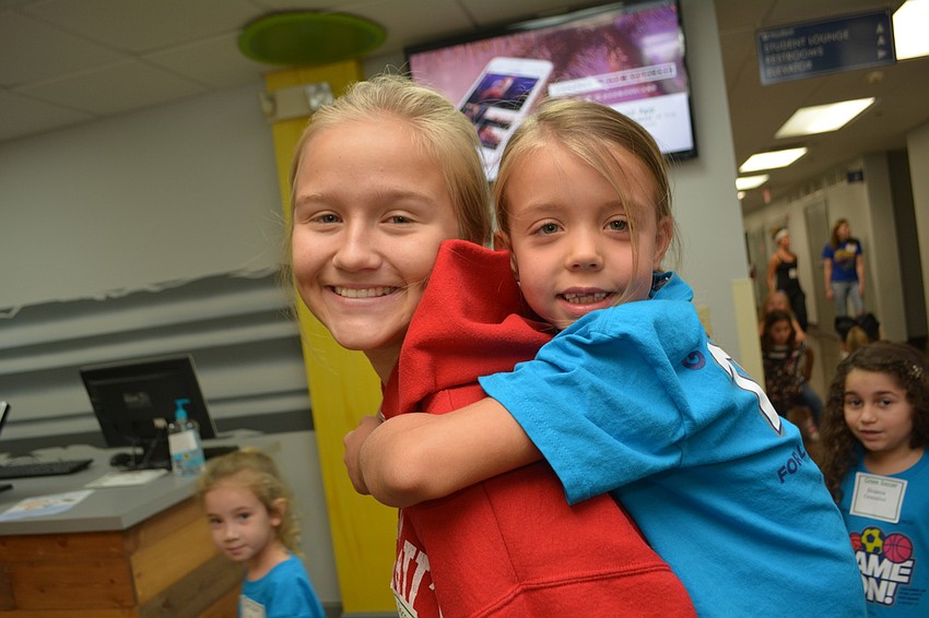Upcoming Braden River High School sophomore Katie Cramer gives a ride to 6-year-old Audrey Stone.