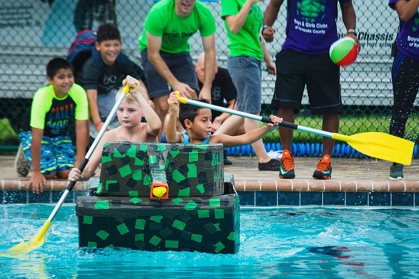 Blake N. and Aiden M. row their boat called 