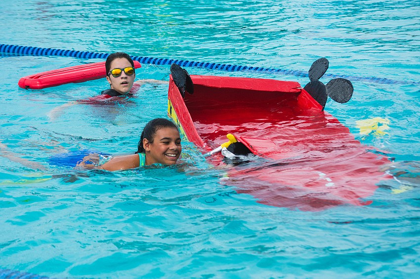Alyssia B. swims her way to the finish line after her boat takes too much water.