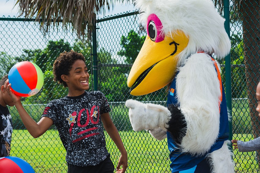Jeremiah B. dances with Scully, the World Rowing Championship’s pelican mascot.