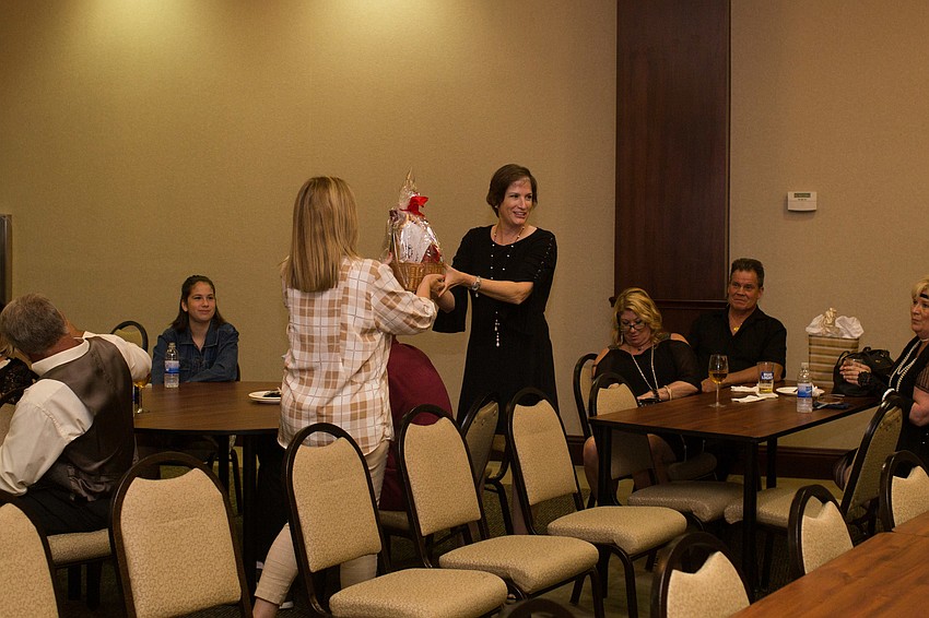 Cynthia Holliday collects the gift basket she won in the raffle.